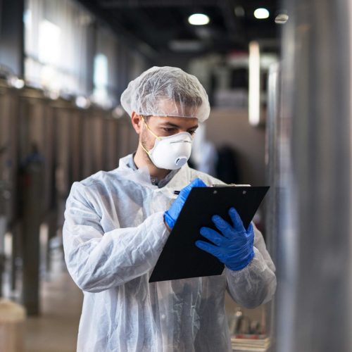 technologist-white-uniform-checking-quality-industrial-production-factory-WEB-scaled.jpg
